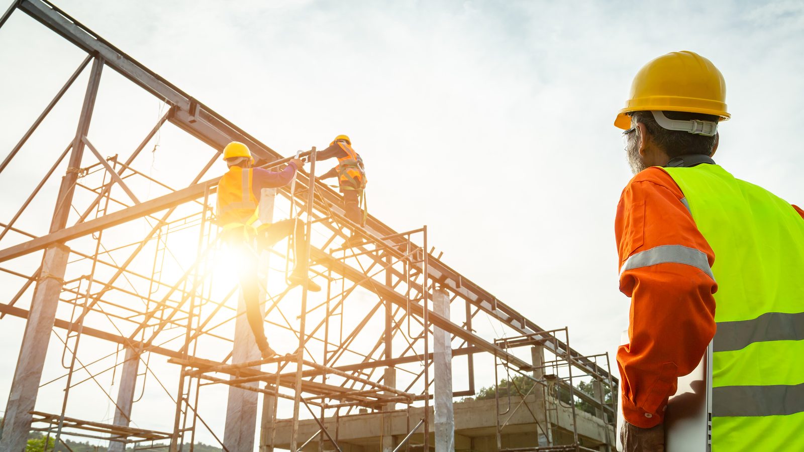 Construction workers climbing scaffolding