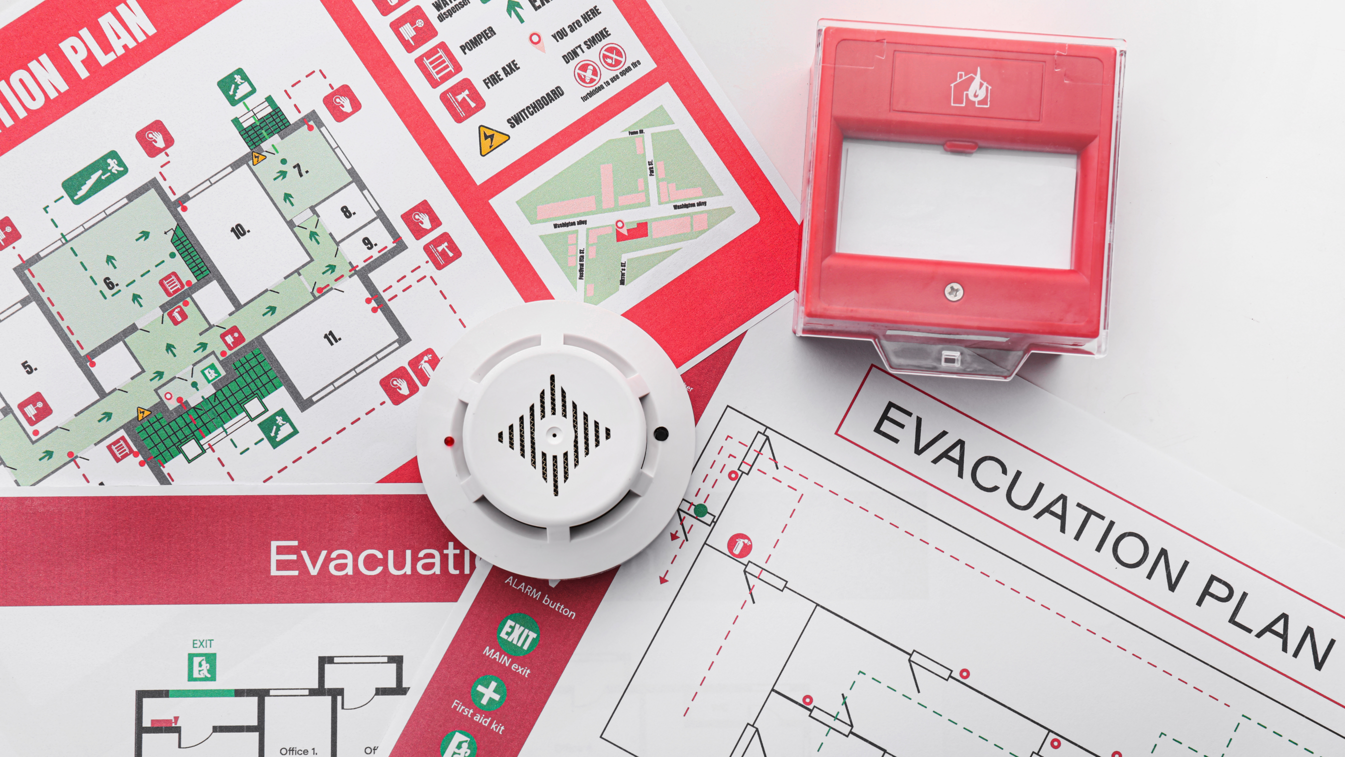 A pile of evacuation plans and fire alarms.